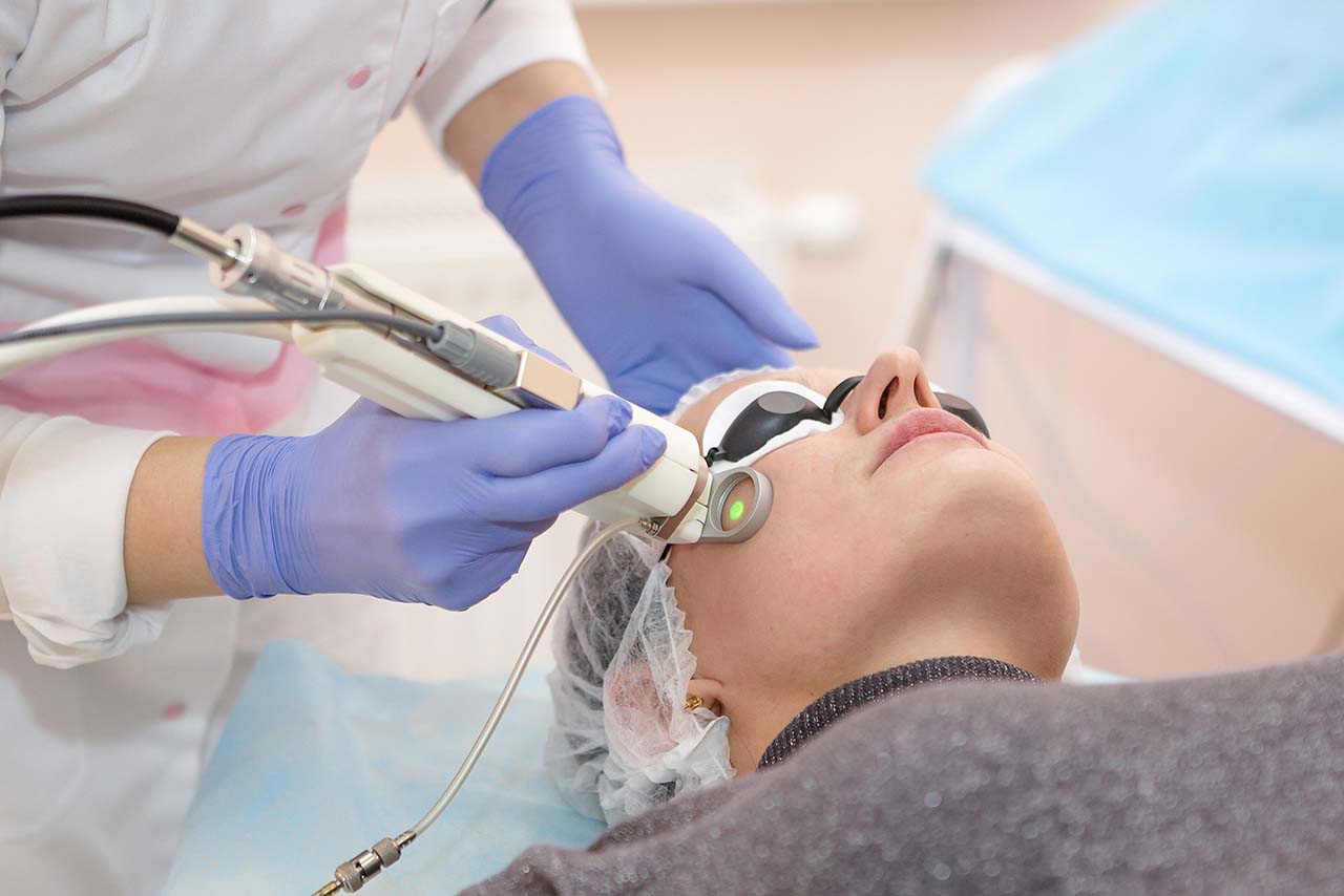 patient receiving a laser treatment on her face Gentle laser treatment on a patient's face at Body Soul Nutrition Regenerative Institute.