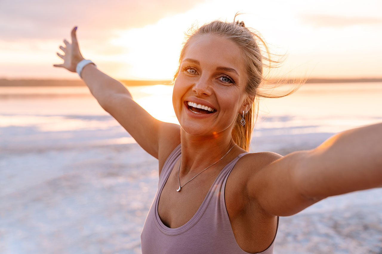 woman celebrating being free from chronic pain Woman celebrating relief from chronic pain after successful pain management treatment.