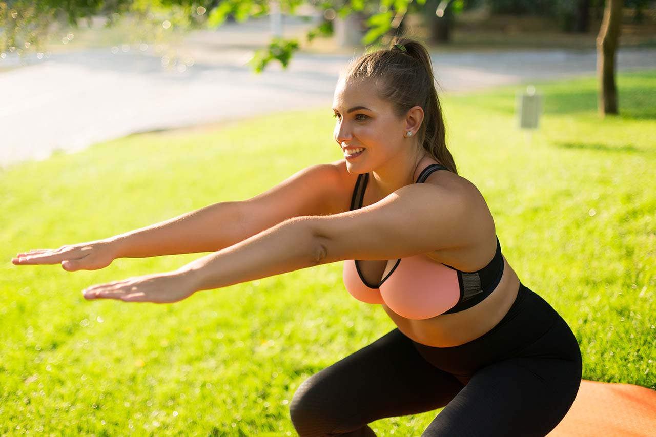 woman exercises outside in the morning Woman exercising outdoors, promoting weight loss management and healthy living.